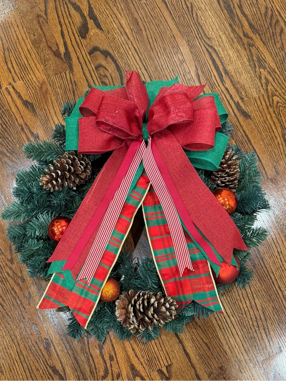 Classic Red & Green Holiday Wreath with Decorative Bow and Pinecones